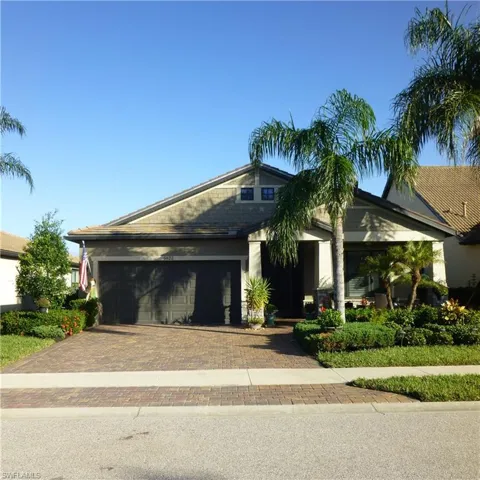 front facade with porch and a garage.