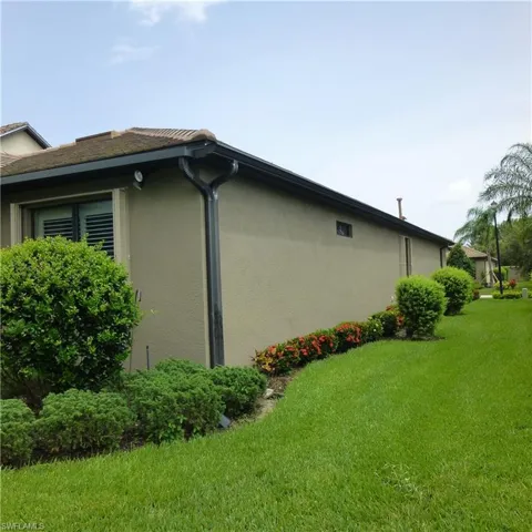 View of property exterior featuring a lawn