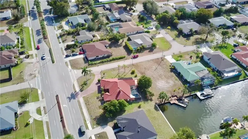 Aerial view of residential area featuring a gulf access canal.r