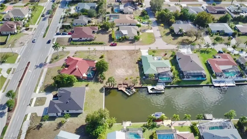 Aerial overview of property's location with nearby suburban area and a gulf access canal