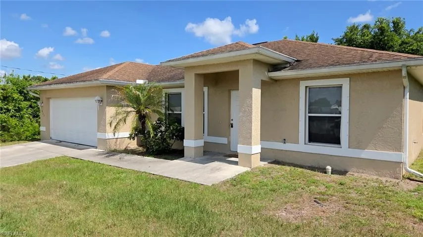 Exterior stucco finish with a two-car garage, covered entry, and single-hung windows
