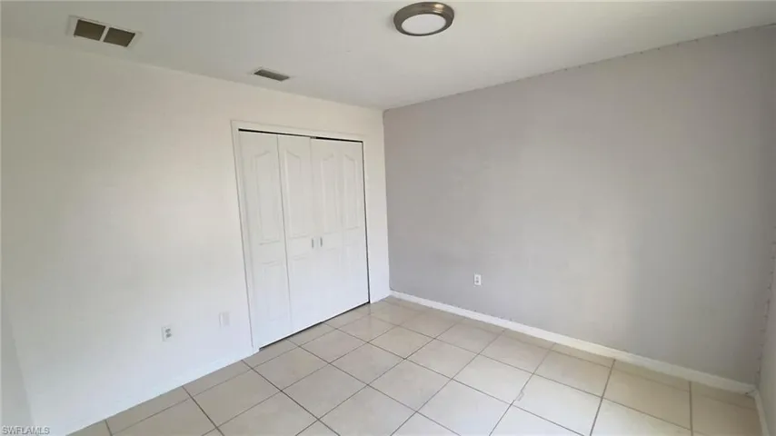 Room featuring light tile flooring and neutral painted walls