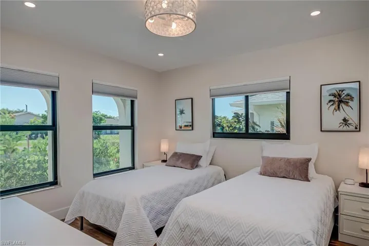 Bedroom with recessed lighting, wood finished floors, and a chandelier