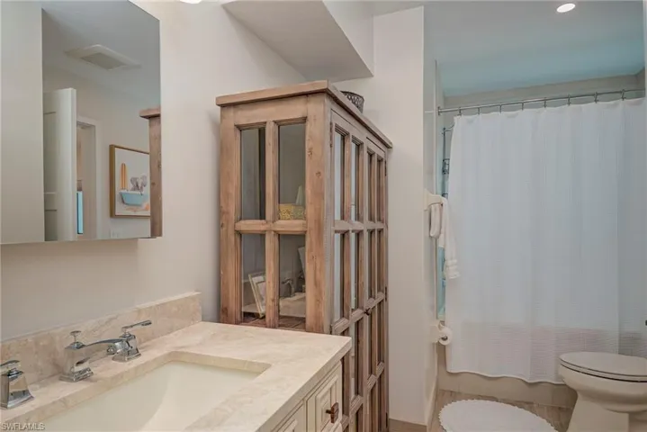 Full bath with vanity, shower / bathtub combination with curtain, and recessed lighting