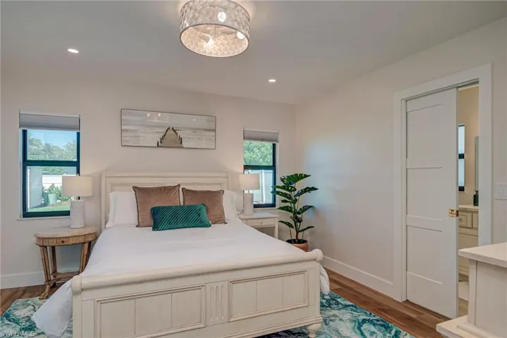 Bedroom with wood finished floors and recessed lighting
