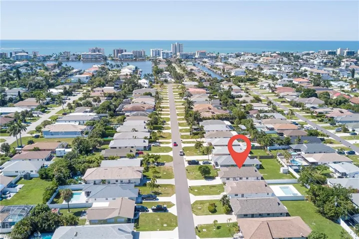 Aerial perspective of suburban area featuring a nearby body of water