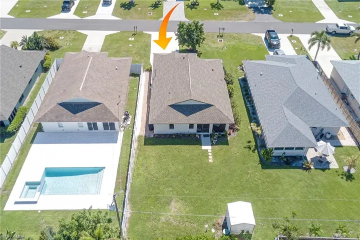 Aerial perspective of suburban area featuring a pool