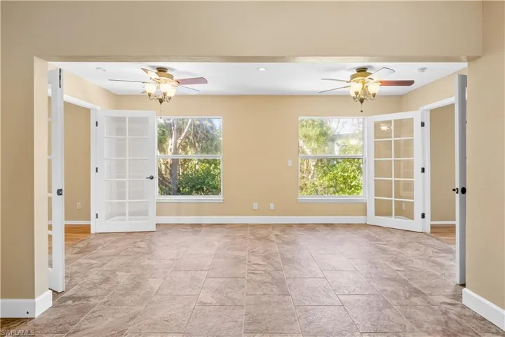 Empty room featuring a ceiling fan and recessed lighting