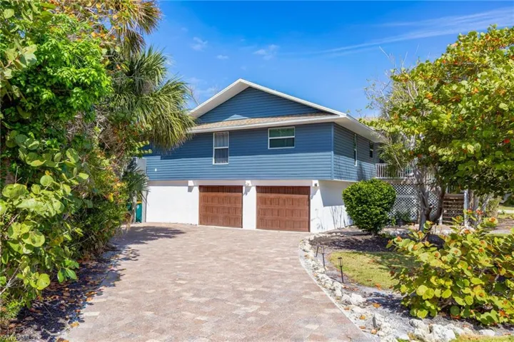 View of front of property featuring decorative driveway and an attached garage