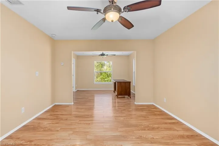 Spare room featuring light wood-type flooring and a ceiling fan