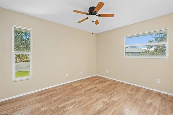 Spare room with light wood finished floors and a ceiling fan