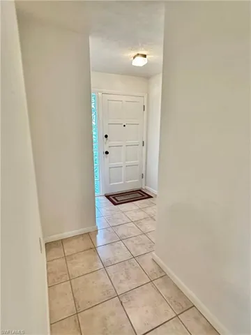 Foyer entrance featuring light tile floors