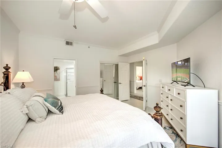 Bedroom featuring a ceiling fan and crown molding