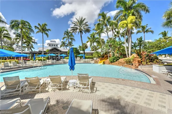 Community pool featuring a water slide and a patio area