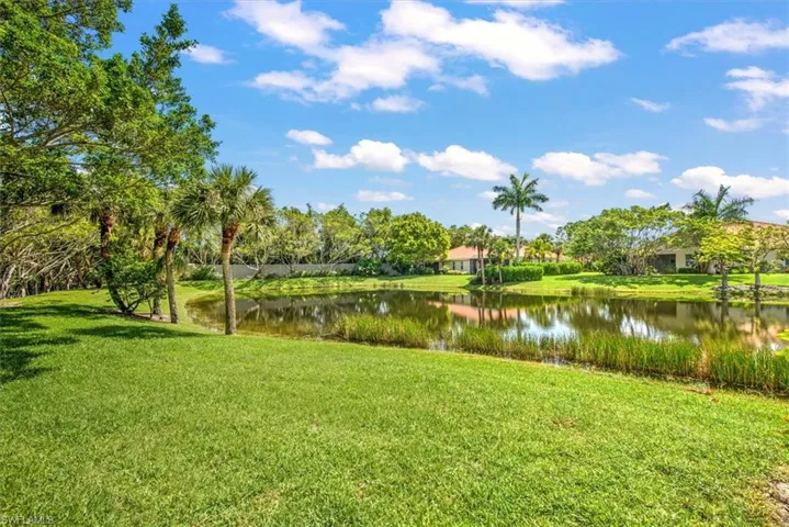 Surrounding community featuring a water view and a yard