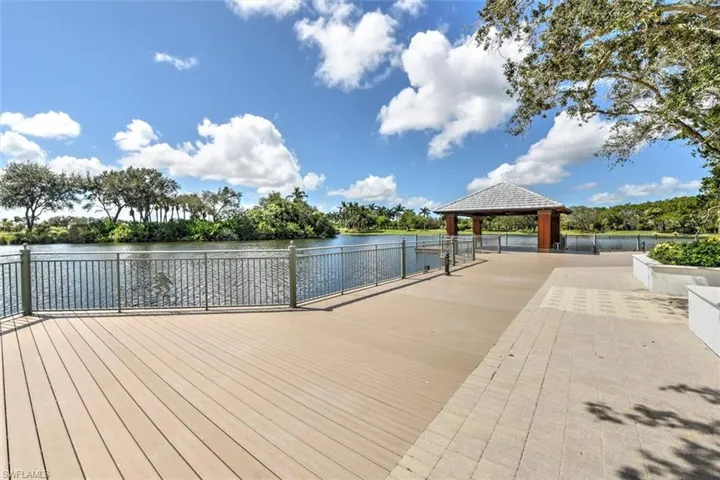 Dock area featuring a water view and view of scattered trees