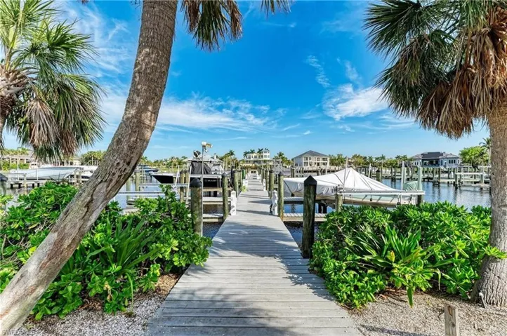 Dock featuring boat lift and a water view