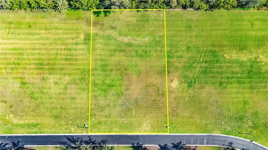 Aerial view of property and surrounding area featuring property parcel outlined
