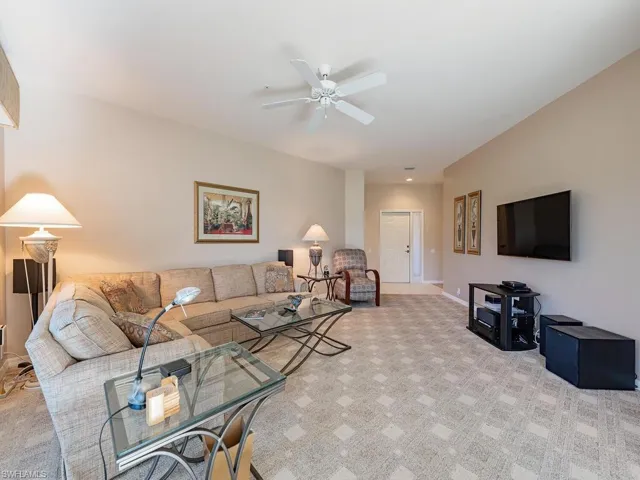 Living room featuring light carpet and ceiling fan