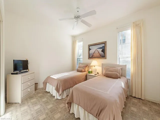Bedroom featuring light colored carpet and ceiling fan