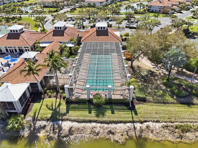 Aerial view of residential area featuring a nearby body of water
