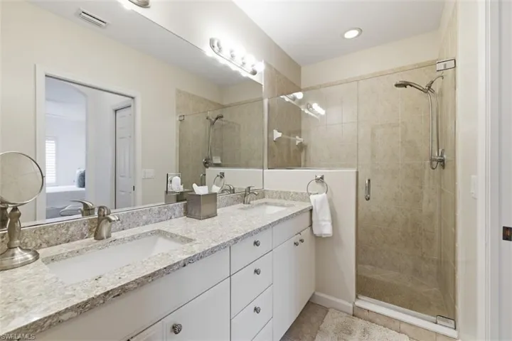 Ensuite bathroom with double vanity and a stall shower