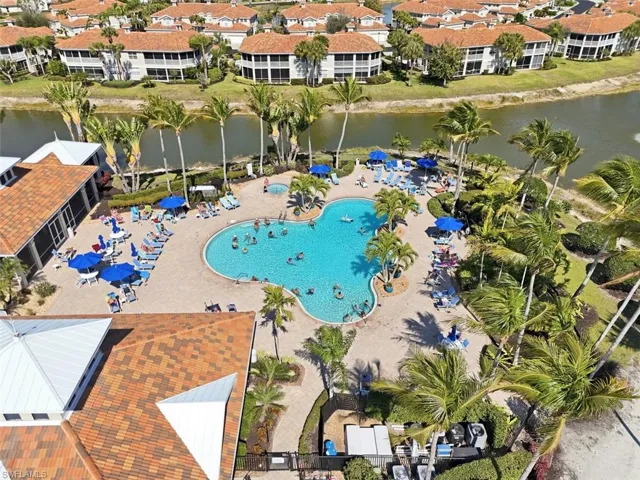 Drone / aerial view of a pool and a large body of water