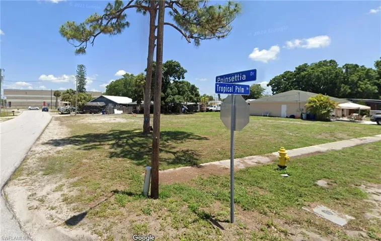 Community / neighborhood sign featuring a lawn