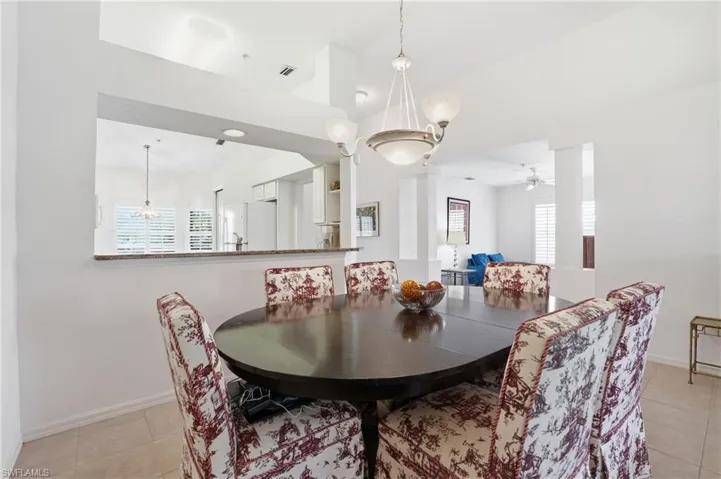 Dining area with light tile patterned floors, ceiling fan, and plenty of natural light