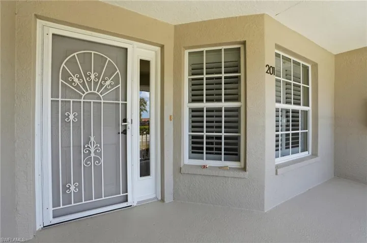 Property entrance featuring stucco siding