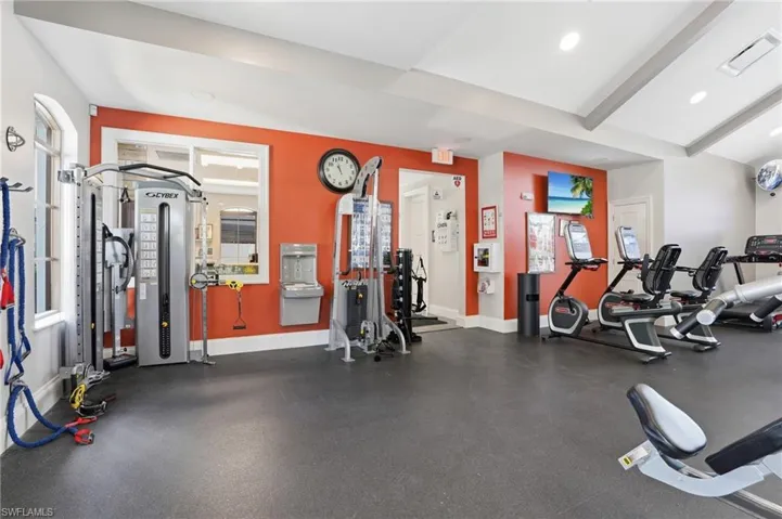 Exercise room featuring beamed ceiling and recessed lighting