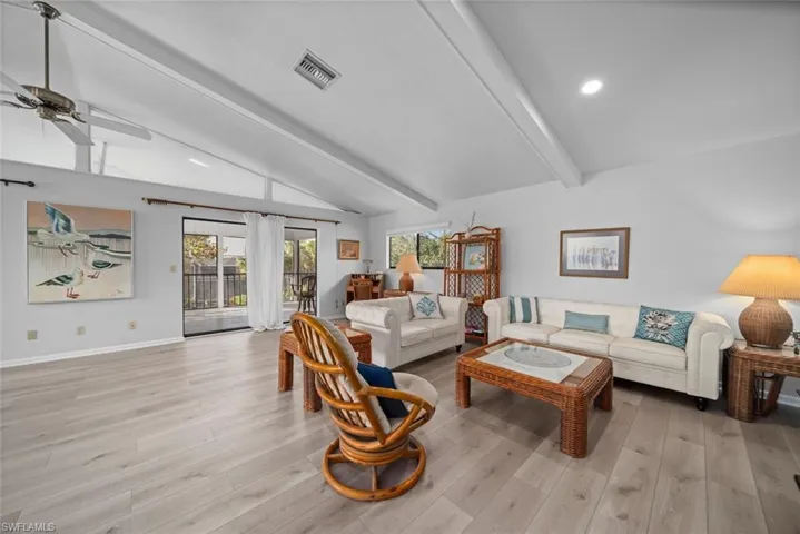 Living room featuring light wood-style floors, a ceiling fan, baseboards, and recessed lighting