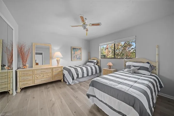Bedroom with wood finished floors and a ceiling fan