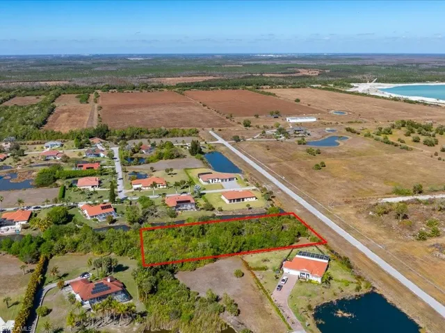 Overview of rural landscape with property parcel outlined and a large body of water