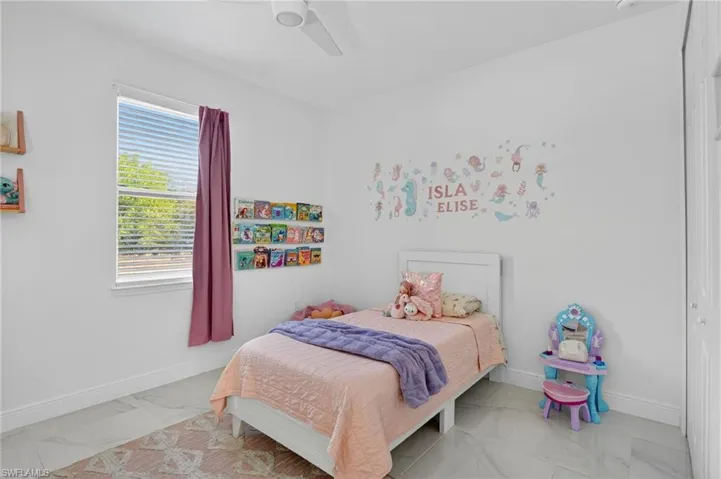 Bedroom featuring ceiling fan and a closet