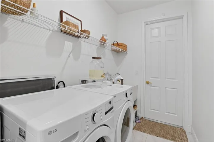 Laundry room featuring independent washer and dryer and baseboards