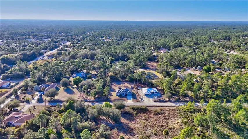 Aerial view of property's location featuring a heavily wooded area