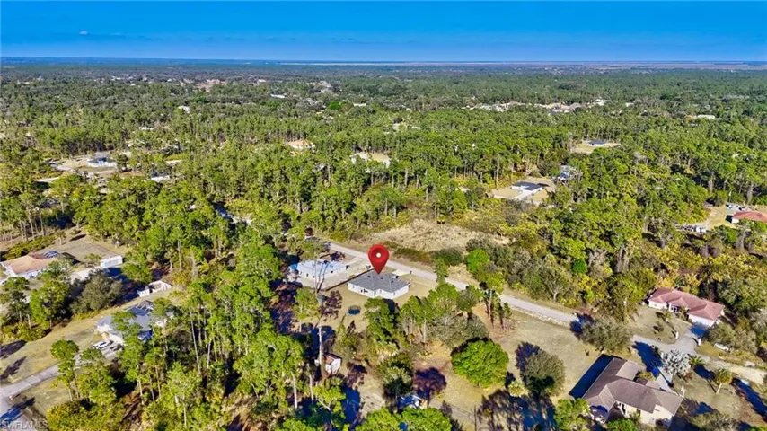 Aerial view of property's location featuring a forest