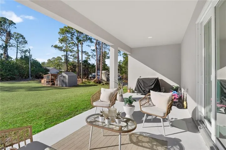 View of patio / terrace featuring a shed and a grill
