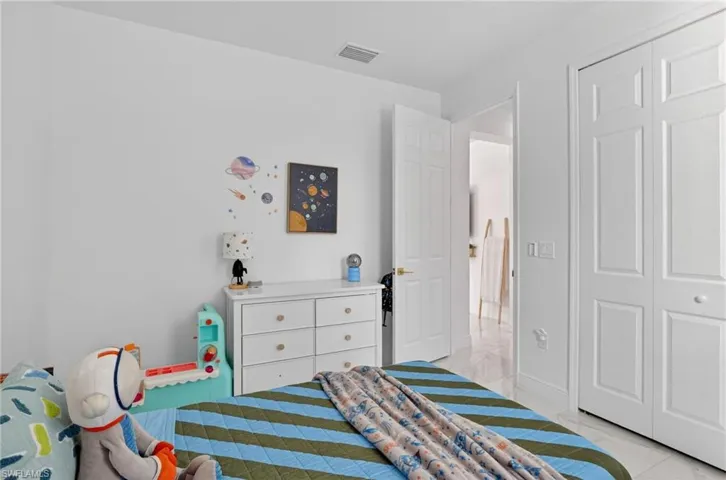 Bedroom featuring a closet and baseboards