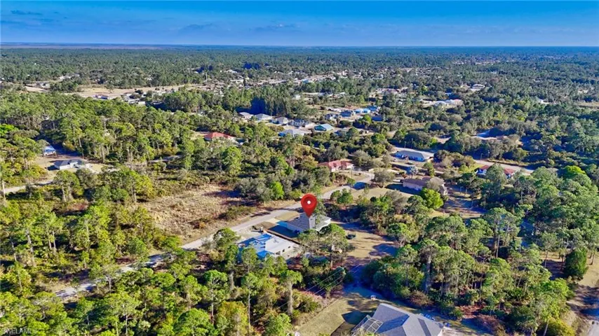 Aerial view of property's location with a forest