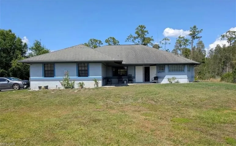 Single story home featuring a front yard and stucco siding