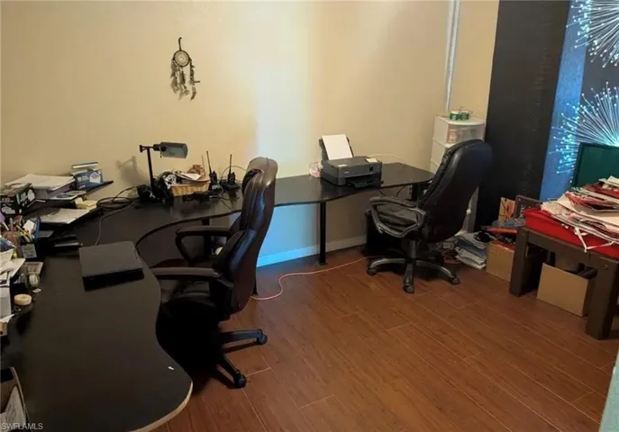 Office area featuring wood finished floors and baseboards