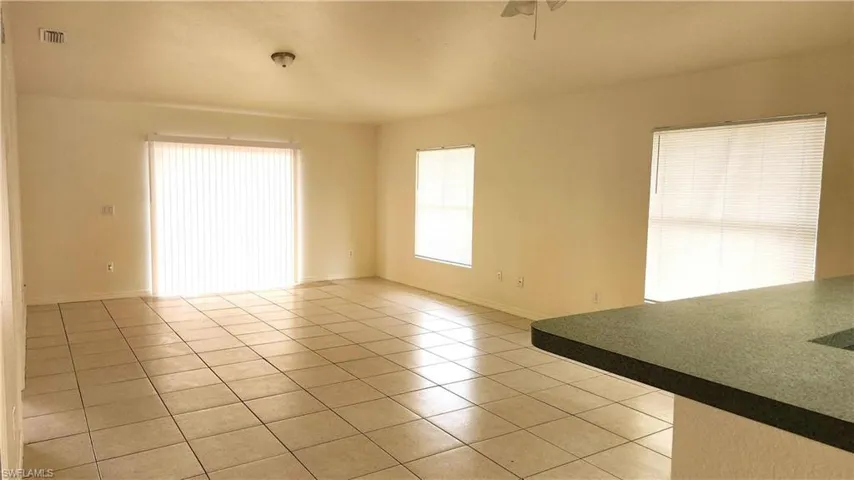 Spare room with light tile patterned flooring and ceiling fan