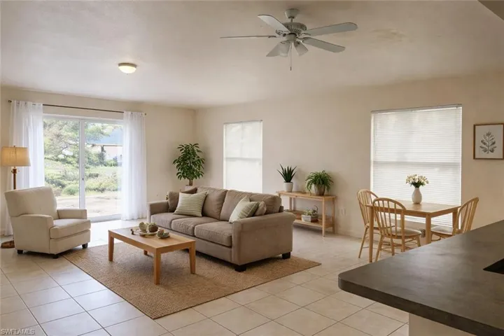Living room featuring ceiling fan and light tile patterned flooring