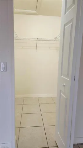 Walk in closet featuring light tile patterned flooring
