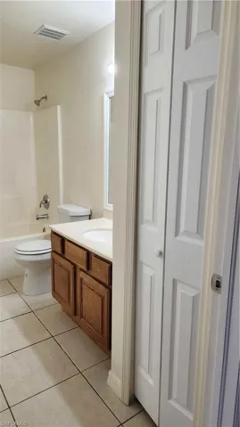 Full bathroom featuring vanity, shower / washtub combination, and light tile patterned flooring