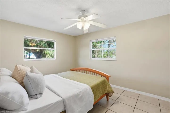 Guest Bedroom #2 features neutral tile flooring and more natural lighting!