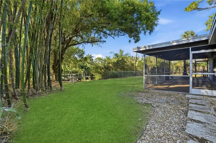 The oversized fenced backyard is complete with bamboo & fruit trees!