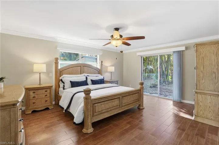 The large Primary Suite features crown molding, tile flooring, and easy access to your Boat dock out back!